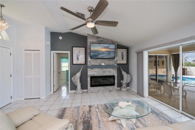 1 Sportsman Cir, Rotonda West, FL 33947 - tiled living area featuring lofted ceiling, plenty of natural light, a fireplace, and a ceiling fan