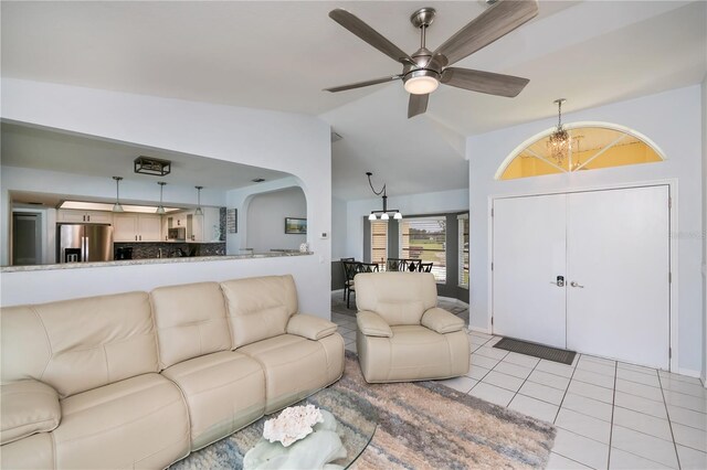 1 Sportsman Cir, Rotonda West, FL 33947 - living area with vaulted ceiling, light tile patterned floors, arched walkways, ceiling fan, and a chandelier