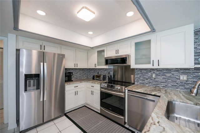 1 Sportsman Cir, Rotonda West, FL 33947 - kitchen with stainless steel appliances, light stone countertops, white cabinetry, glass insert cabinets, and recessed lighting