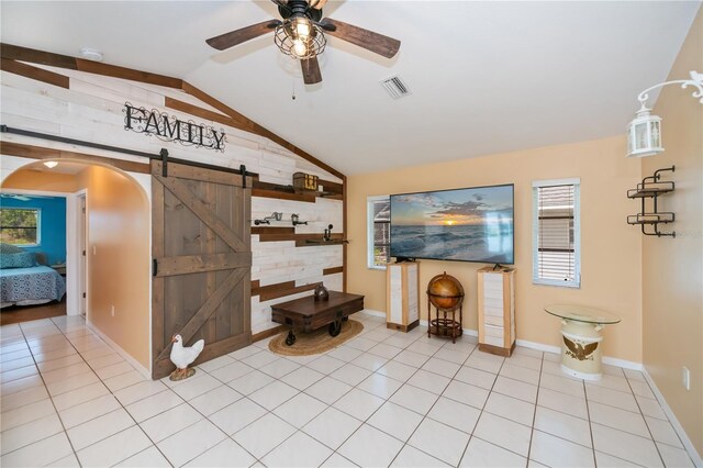 1 Sportsman Cir, Rotonda West, FL 33947 - living area with a barn door, vaulted ceiling, ceiling fan, light tile patterned floors, and arched walkways
