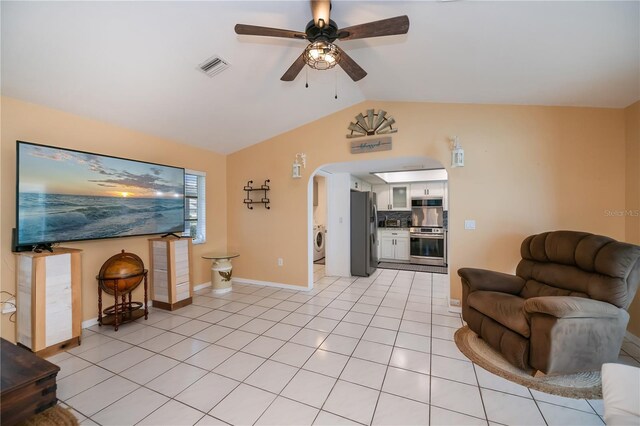 1 Sportsman Cir, Rotonda West, FL 33947 - living room with lofted ceiling, a ceiling fan, washer / clothes dryer, arched walkways, and light tile patterned floors