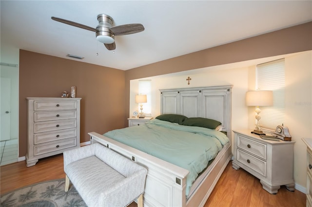 1 Sportsman Cir, Rotonda West, FL 33947 - bedroom with light wood finished floors and a ceiling fan