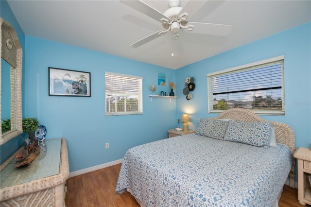 1 Sportsman Cir, Rotonda West, FL 33947 - bedroom with multiple windows, wood finished floors, and a ceiling fan