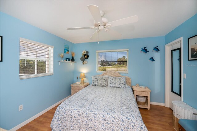 1 Sportsman Cir, Rotonda West, FL 33947 - bedroom featuring wood finished floors, multiple windows, and ceiling fan