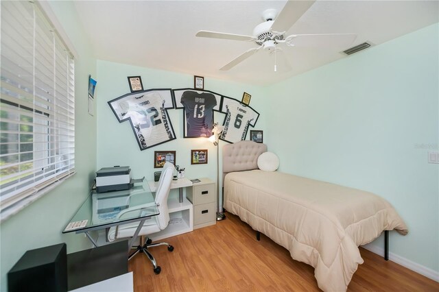 1 Sportsman Cir, Rotonda West, FL 33947 - bedroom featuring wood finished floors, an office area, and a ceiling fan