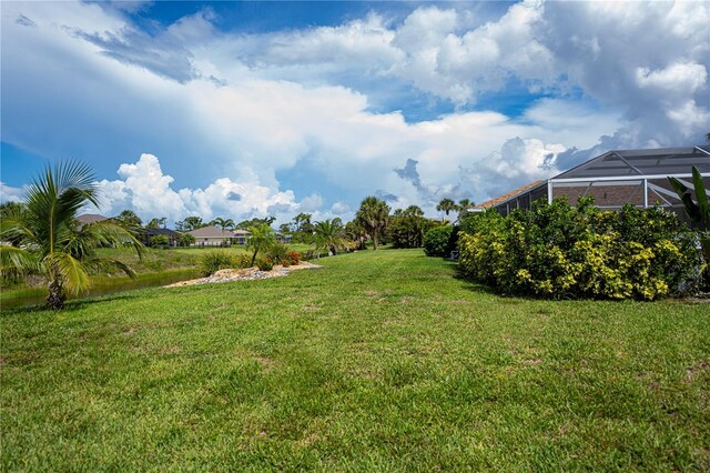 1 Sportsman Cir, Rotonda West, FL 33947 - view of grassy yard with glass enclosure