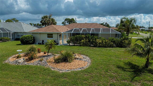 1 Sportsman Cir, Rotonda West, FL 33947 - back of house with a yard, stucco siding, and a lanai
