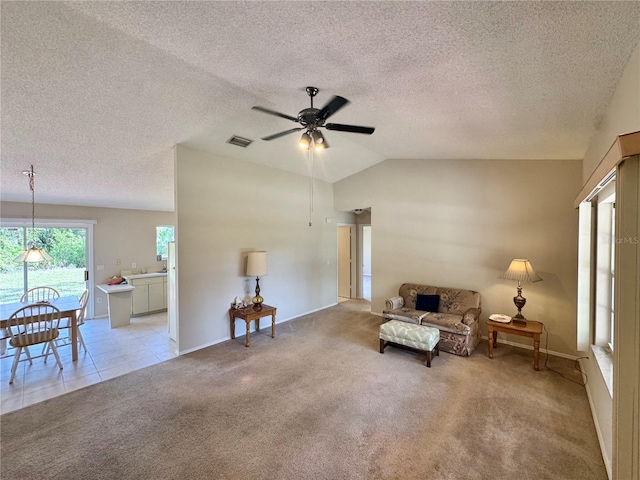 18335 Oxford Ave, Port Charlotte, FL 33948 - living area with ceiling fan, light colored carpet, lofted ceiling, a textured ceiling, and baseboards