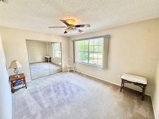 18335 Oxford Ave, Port Charlotte, FL 33948 - carpeted empty room with a ceiling fan, a textured ceiling, and baseboards