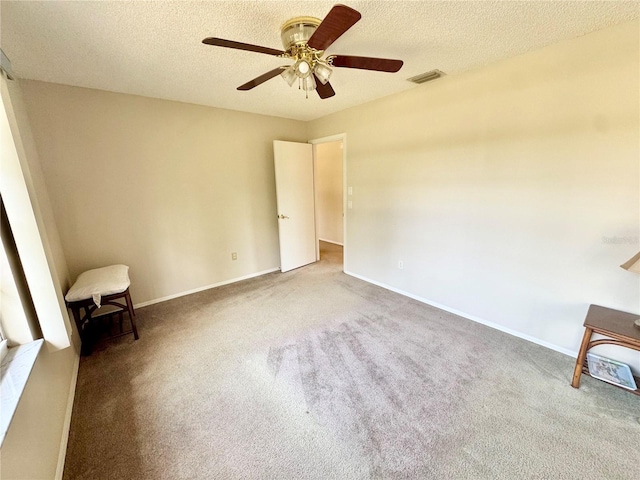 18335 Oxford Ave, Port Charlotte, FL 33948 - unfurnished bedroom with carpet flooring, a textured ceiling, baseboards, and ceiling fan