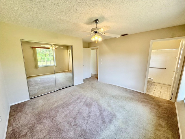 18335 Oxford Ave, Port Charlotte, FL 33948 - unfurnished bedroom featuring carpet floors, a closet, a textured ceiling, baseboards, and ceiling fan