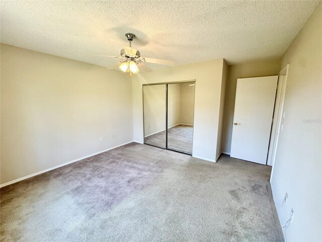18335 Oxford Ave, Port Charlotte, FL 33948 - unfurnished bedroom with carpet, a closet, a textured ceiling, a ceiling fan, and baseboards