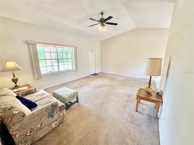 18335 Oxford Ave, Port Charlotte, FL 33948 - living room with a ceiling fan, carpet, a textured ceiling, vaulted ceiling, and baseboards