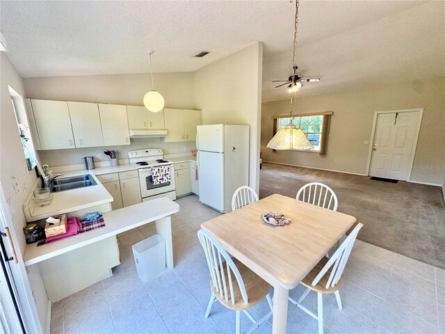 18335 Oxford Ave, Port Charlotte, FL 33948 - dining room with vaulted ceiling, a textured ceiling, light tile patterned floors, a ceiling fan, and light carpet