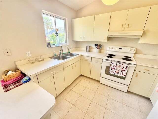 18335 Oxford Ave, Port Charlotte, FL 33948 - kitchen featuring white range with electric stovetop, a sink, under cabinet range hood, light countertops, and light tile patterned floors