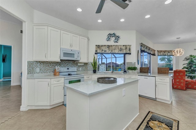 1499 Nuremberg Blvd, Punta Gorda, FL 33983 - kitchen featuring white appliances, a peninsula, ceiling fan, white cabinetry, and recessed lighting