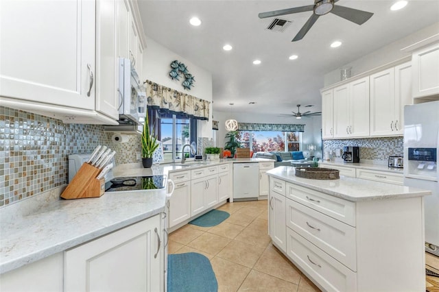 1499 Nuremberg Blvd, Punta Gorda, FL 33983 - kitchen with a ceiling fan, white appliances, recessed lighting, decorative backsplash, and a center island