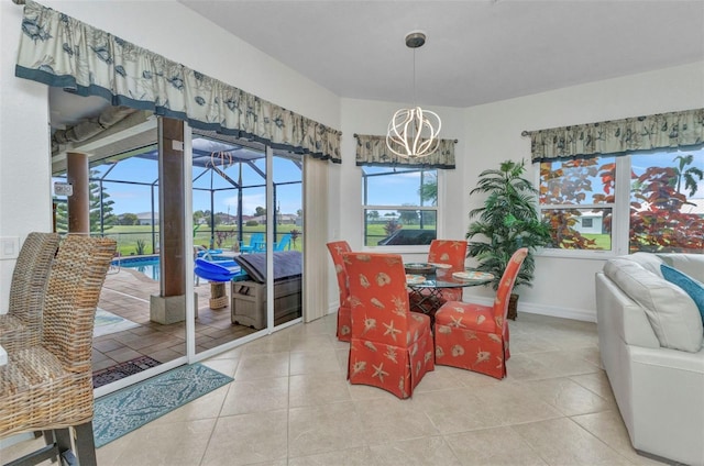 1499 Nuremberg Blvd, Punta Gorda, FL 33983 - dining space featuring a chandelier, a sunroom, light tile patterned floors, and baseboards