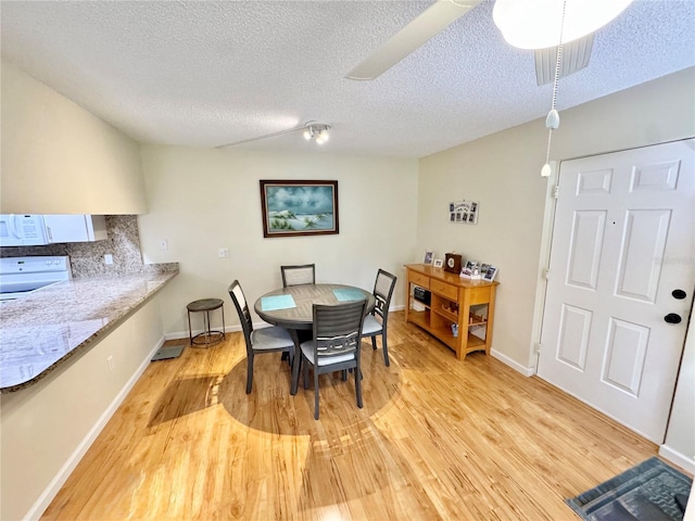 1515 Forrest Nelson Blvd Unit D102, Port Charlotte, FL 33952 - dining area with light wood-style flooring, a textured ceiling, and baseboards
