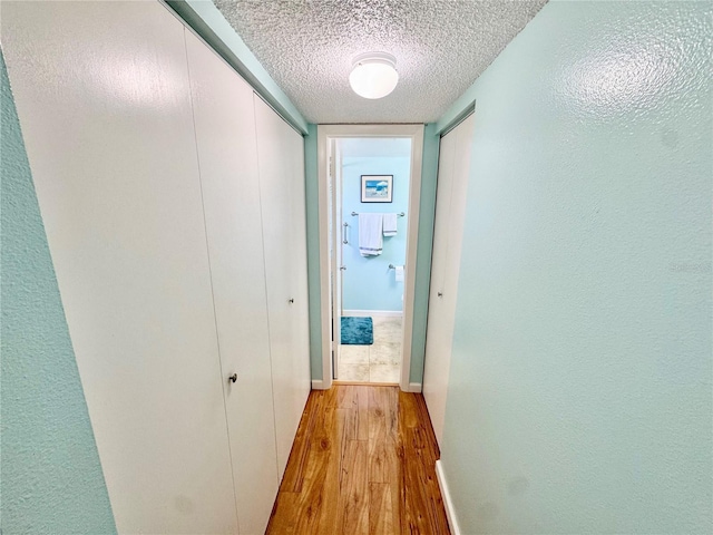 1515 Forrest Nelson Blvd Unit D102, Port Charlotte, FL 33952 - hall with a textured ceiling, wood finished floors, and baseboards