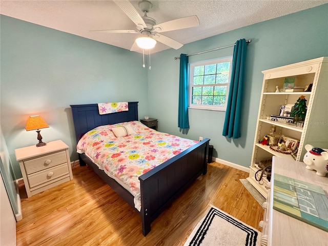 1515 Forrest Nelson Blvd Unit D102, Port Charlotte, FL 33952 - bedroom featuring wood finished floors, baseboards, ceiling fan, and a textured ceiling