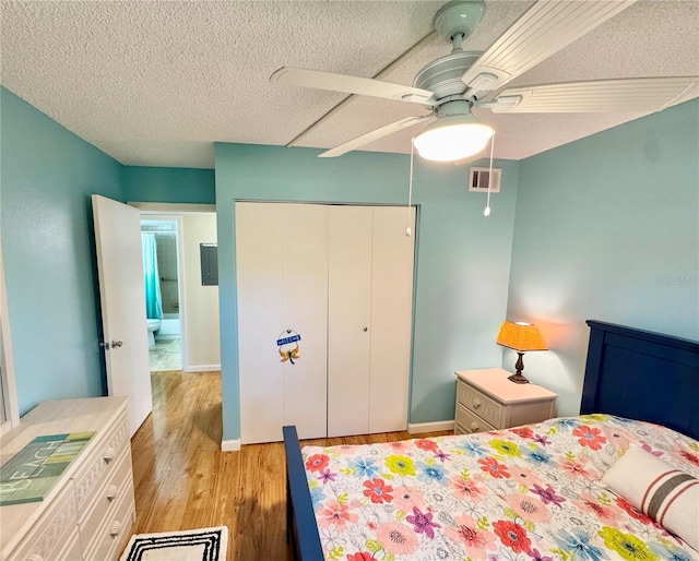 1515 Forrest Nelson Blvd Unit D102, Port Charlotte, FL 33952 - bedroom featuring light wood-style floors, a closet, a textured ceiling, a ceiling fan, and baseboards