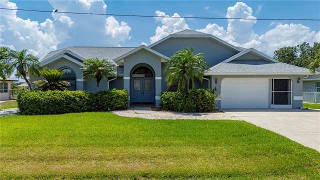 25371 Paladin Ln, Punta Gorda, FL 33983 - view of front facade featuring stucco siding, a garage, a front yard, and driveway