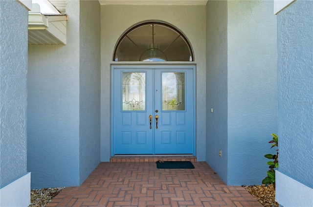 25371 Paladin Ln, Punta Gorda, FL 33983 - view of exterior entry featuring stucco siding and french doors