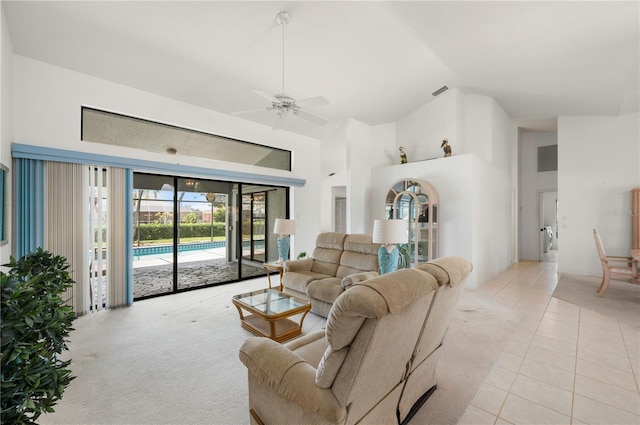 25371 Paladin Ln, Punta Gorda, FL 33983 - living area featuring high vaulted ceiling, ceiling fan, light tile patterned floors, and light carpet