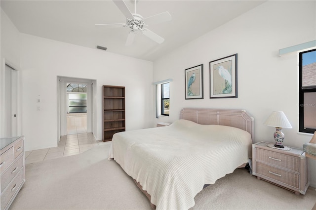 25371 Paladin Ln, Punta Gorda, FL 33983 - bedroom featuring light carpet, light tile patterned floors, a ceiling fan, and baseboards
