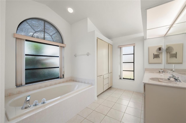 25371 Paladin Ln, Punta Gorda, FL 33983 - bathroom featuring a bath, double vanity, tile patterned floors, and lofted ceiling