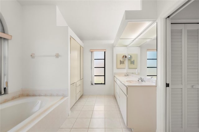 25371 Paladin Ln, Punta Gorda, FL 33983 - full bath featuring a closet, double vanity, a garden tub, and healthy amount of natural light