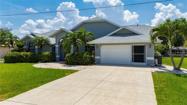 25371 Paladin Ln, Punta Gorda, FL 33983 - view of front of home with driveway, stucco siding, a front yard, an attached garage, and central AC unit