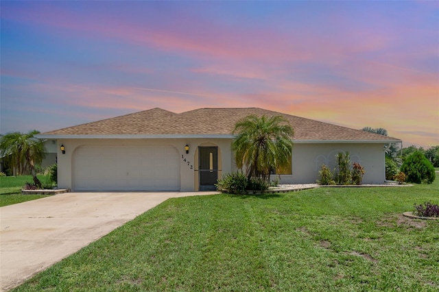 1472 Oriel Ct, Punta Gorda, FL 33983 - ranch-style house featuring stucco siding, a garage, driveway, and a front lawn