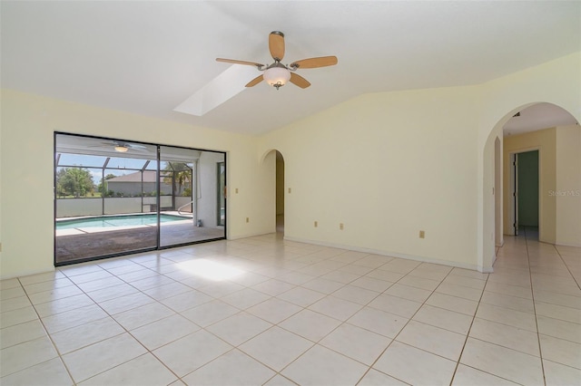 1472 Oriel Ct, Punta Gorda, FL 33983 - empty room with ceiling fan, vaulted ceiling, light tile patterned flooring, and arched walkways