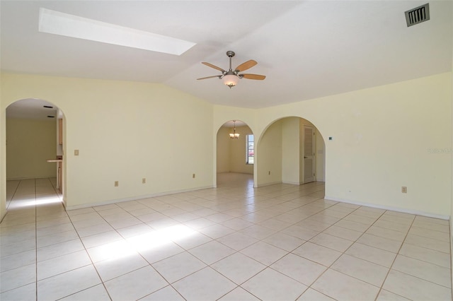 1472 Oriel Ct, Punta Gorda, FL 33983 - spare room with a ceiling fan, light tile patterned floors, lofted ceiling, arched walkways, and baseboards