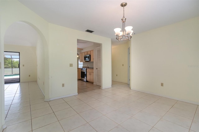 1472 Oriel Ct, Punta Gorda, FL 33983 - unfurnished room featuring arched walkways, a chandelier, and light tile patterned flooring