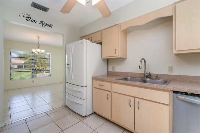 1472 Oriel Ct, Punta Gorda, FL 33983 - kitchen with dishwasher, a sink, light brown cabinets, white fridge with ice dispenser, and light countertops