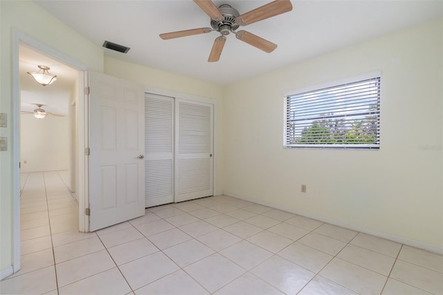 1472 Oriel Ct, Punta Gorda, FL 33983 - unfurnished bedroom featuring a closet, light tile patterned floors, and ceiling fan