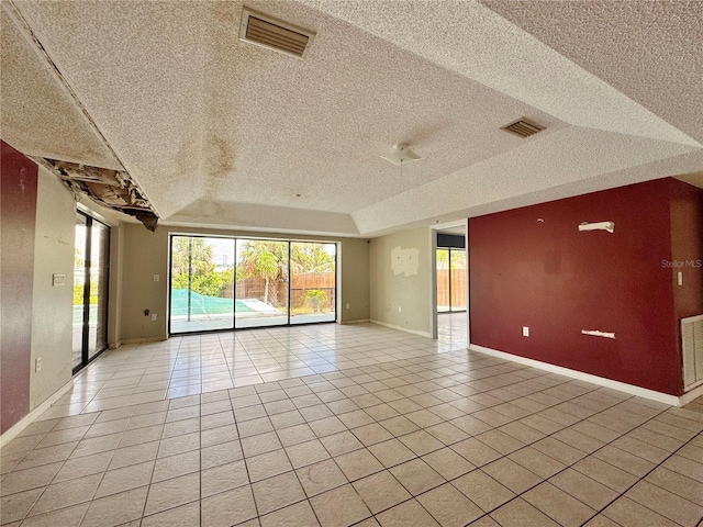 1611 Robbins Rd, Nokomis, FL 34275 - unfurnished room with a textured ceiling, light tile patterned floors, baseboards, and plenty of natural light