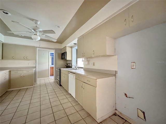 1611 Robbins Rd, Nokomis, FL 34275 - kitchen with stove, white dishwasher, black microwave, a sink, and ceiling fan