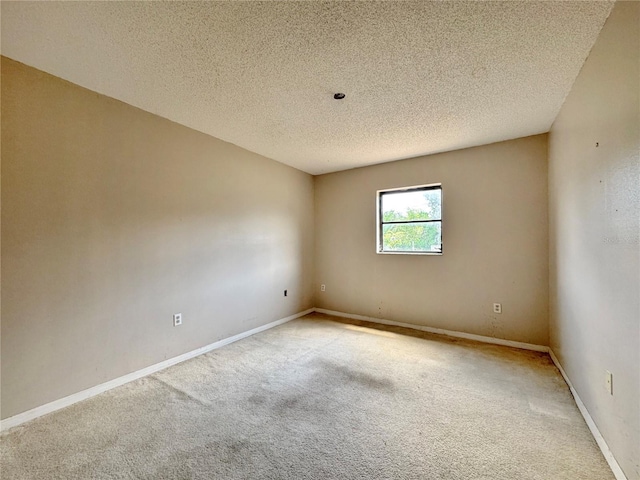 1611 Robbins Rd, Nokomis, FL 34275 - spare room featuring carpet, a textured ceiling, and baseboards