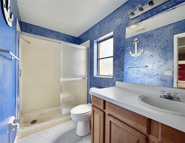 1611 Robbins Rd, Nokomis, FL 34275 - bathroom featuring toilet, vanity, a stall shower, tile patterned floors, and wallpapered walls