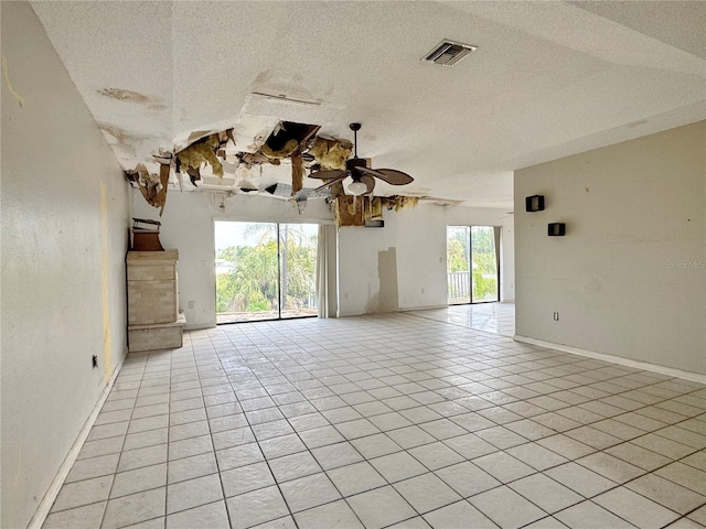 1611 Robbins Rd, Nokomis, FL 34275 - empty room featuring a textured ceiling, light tile patterned floors, ceiling fan, and baseboards