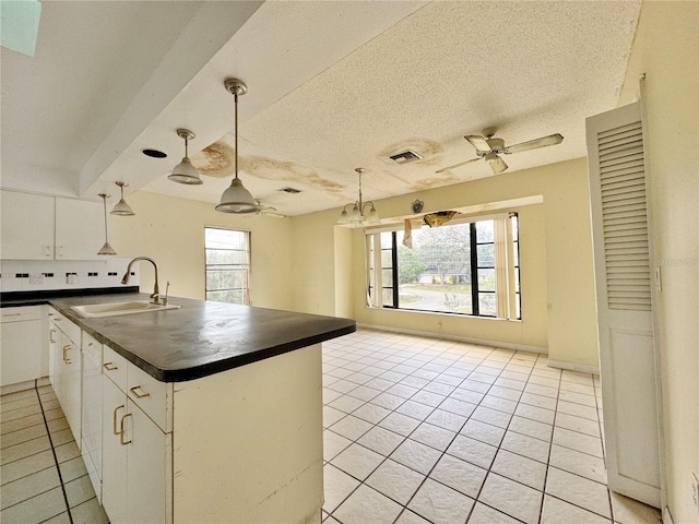 1611 Robbins Rd, Nokomis, FL 34275 - kitchen with a sink, dark countertops, ceiling fan, light tile patterned floors, and a textured ceiling