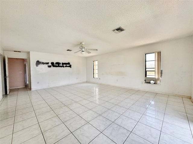 1611 Robbins Rd, Nokomis, FL 34275 - unfurnished room featuring ceiling fan, a textured ceiling, light tile patterned floors, and baseboards