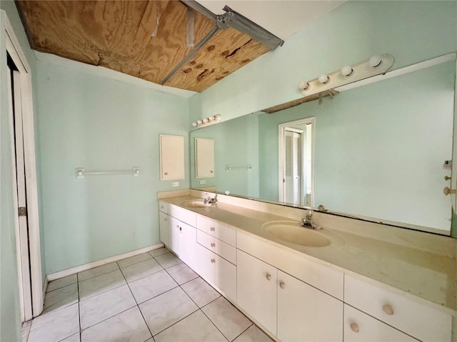 1611 Robbins Rd, Nokomis, FL 34275 - bathroom featuring double vanity, tile patterned floors, and baseboards