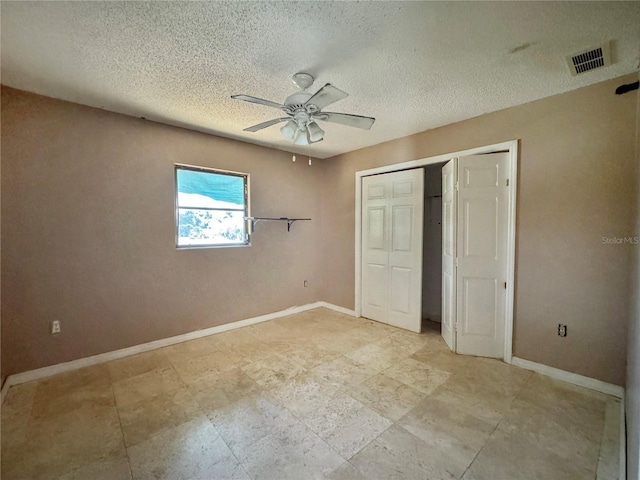 1611 Robbins Rd, Nokomis, FL 34275 - unfurnished bedroom with a closet, a textured ceiling, a ceiling fan, and baseboards