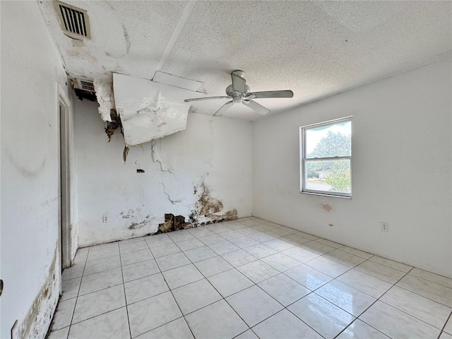 1611 Robbins Rd, Nokomis, FL 34275 - spare room featuring light tile patterned floors, ceiling fan, and a textured ceiling
