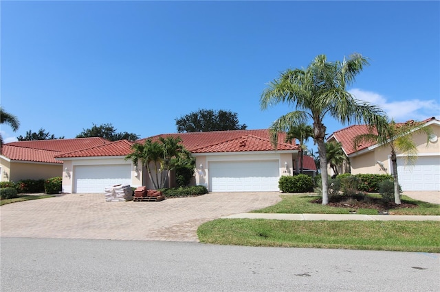 3803 Albacete Cir Unit 64, Punta Gorda, FL 33950 - mediterranean / spanish-style home featuring stucco siding, a tiled roof, an attached garage, and driveway